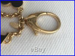 Authentic Louis Vuitton key ring in gold type hardware, black enamel and taupe e