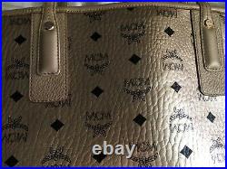 MCM M/L tote gold w black design gold leather pre owned NWOT serial # & sleeper